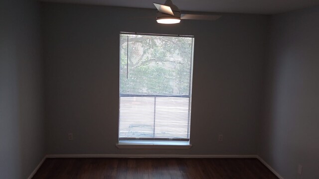 unfurnished room featuring baseboards and wood finished floors