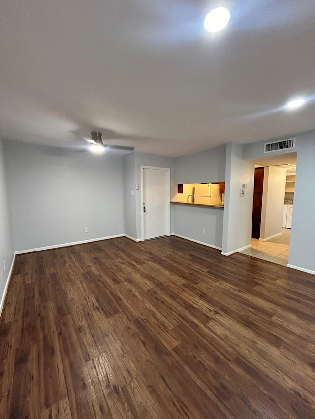 8435 Hearth Dr Unit 21, Houston, TX 77054 - unfurnished living room featuring wood finished floors, a ceiling fan, and baseboards