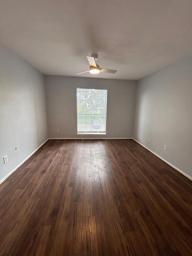 8435 Hearth Dr Unit 21, Houston, TX 77054 - spare room with baseboards, dark wood-style flooring, and ceiling fan