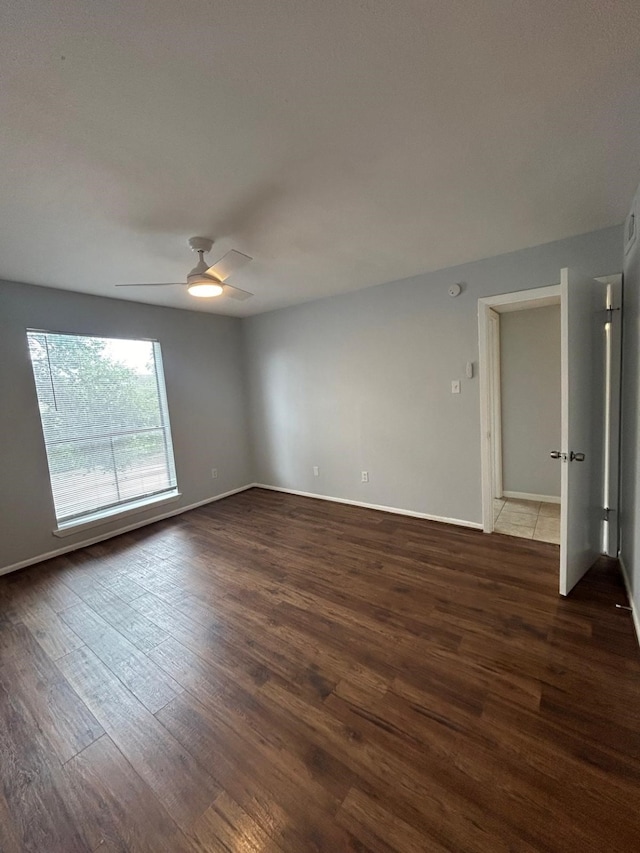 8435 Hearth Dr Unit 21, Houston, TX 77054 - empty room featuring wood finished floors, ceiling fan, and baseboards
