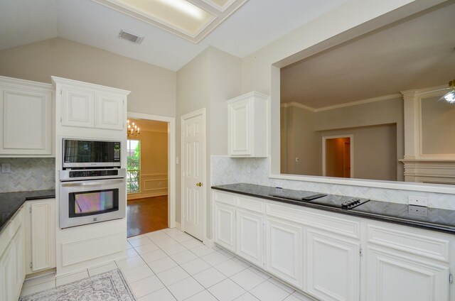 2303 Reflection Ct, Missouri City, TX 77459 - kitchen with stainless steel appliances, dark countertops, light tile patterned floors, backsplash, and white cabinetry