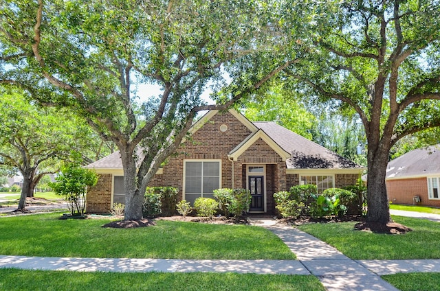 2303 Reflection Ct, Missouri City, TX 77459 - traditional-style home featuring brick siding, a front lawn, and roof with shingles
