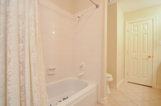 2303 Reflection Ct, Missouri City, TX 77459 - full bath with tile patterned floors, shower / bathtub combination with curtain, toilet, and baseboards