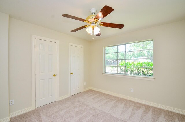 2303 Reflection Ct, Missouri City, TX 77459 - unfurnished bedroom with carpet floors, baseboards, and a ceiling fan