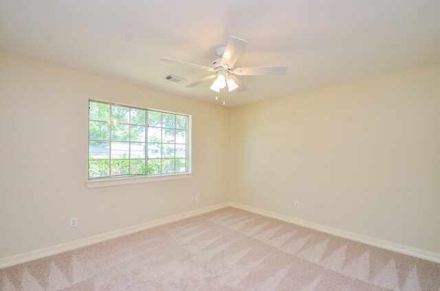 2303 Reflection Ct, Missouri City, TX 77459 - empty room featuring light colored carpet, baseboards, and ceiling fan