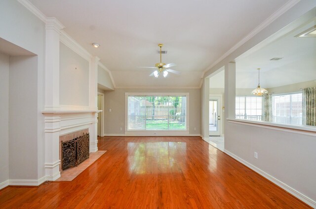2303 Reflection Ct, Missouri City, TX 77459 - unfurnished living room with ceiling fan, wood finished floors, baseboards, a fireplace with flush hearth, and lofted ceiling