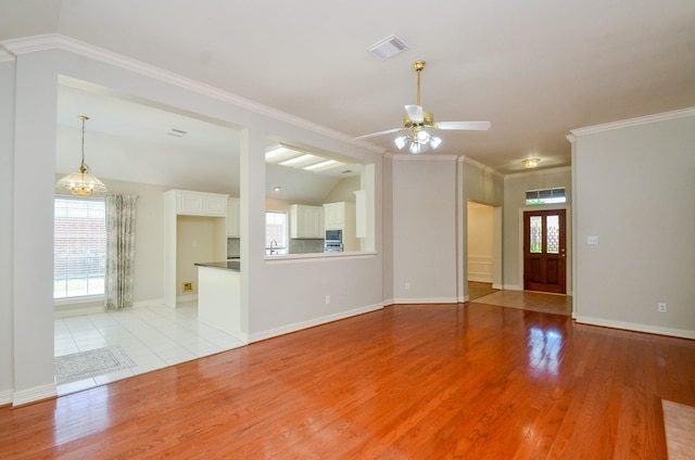 2303 Reflection Ct, Missouri City, TX 77459 - unfurnished living room with crown molding, light wood-type flooring, a ceiling fan, baseboards, and lofted ceiling