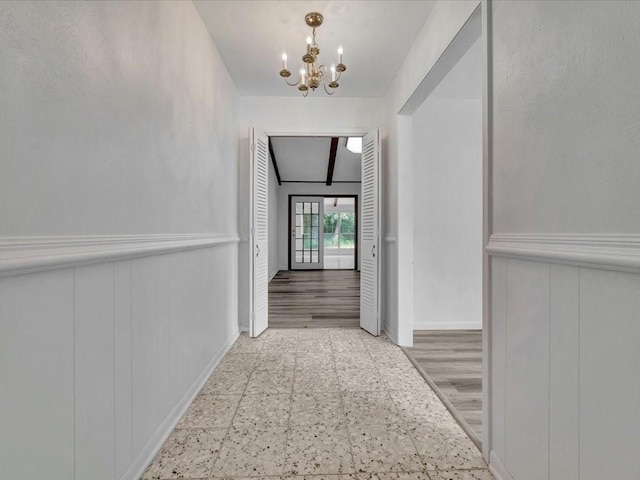 200 Platt Rd, Lufkin, TX 75901 - hall featuring a decorative wall, a chandelier, wainscoting, and baseboards