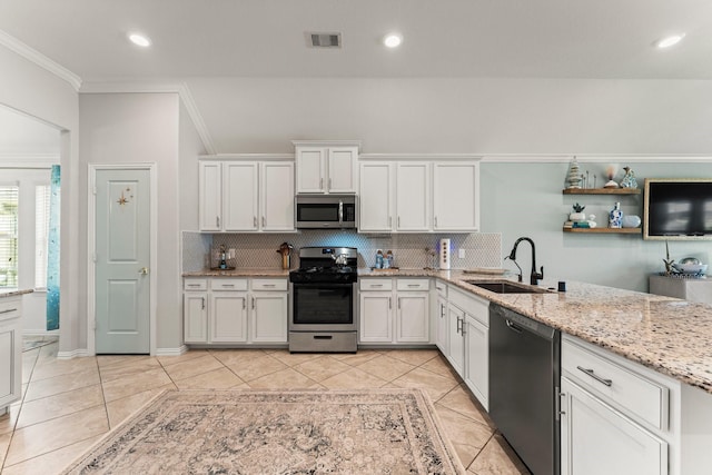 kitchen with stainless steel appliances, a sink, ornamental molding, tasteful backsplash, and white cabinets