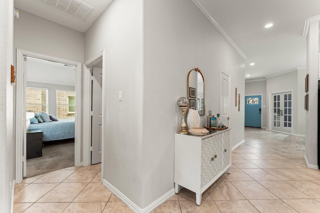 corridor with crown molding, light tile patterned floors, baseboards, and recessed lighting