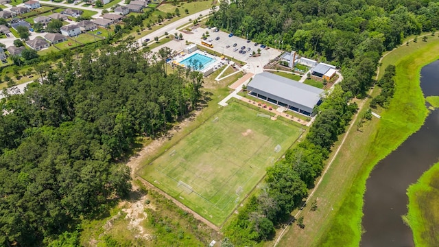 bird's eye view of a nearby body of water and a pool area