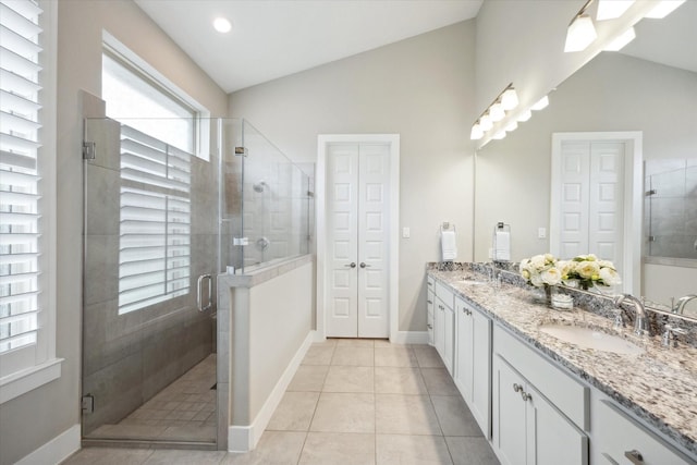809 Stella Vista Ct, Katy, TX 77493 - full bathroom featuring double vanity, a stall shower, baseboards, a closet, and lofted ceiling