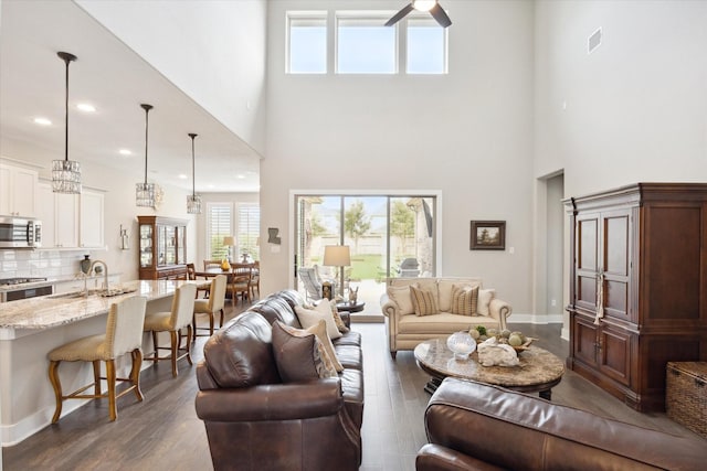 809 Stella Vista Ct, Katy, TX 77493 - living room featuring dark wood-style flooring, a high ceiling, ceiling fan, baseboards, and recessed lighting