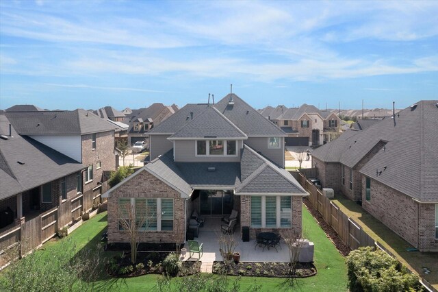 809 Stella Vista Ct, Katy, TX 77493 - back of house featuring a residential view, brick siding, a patio area, and roof with shingles