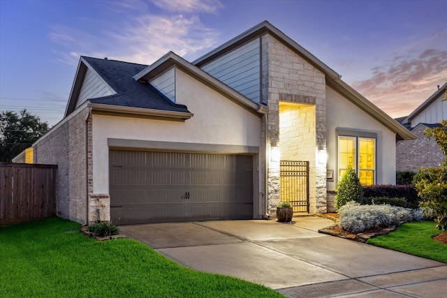 13234 James Terrace Ln, Houston, TX 77059 - view of front of home with stone siding, a garage, driveway, and stucco siding