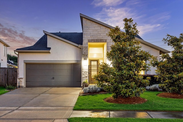 13234 James Terrace Ln, Houston, TX 77059 - view of front facade with stone siding, a garage, stucco siding, and concrete driveway