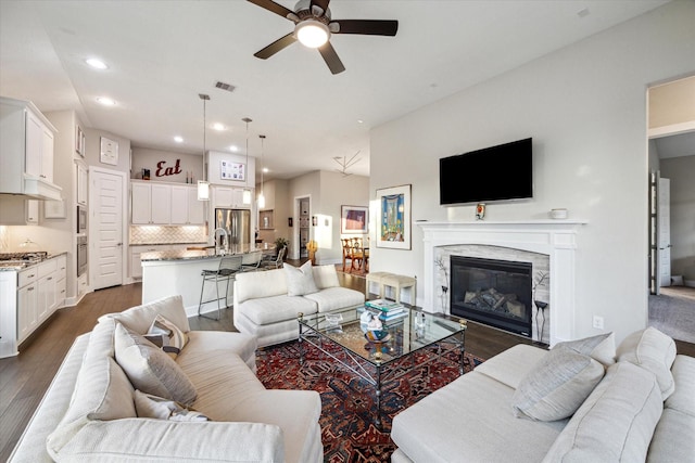 13234 James Terrace Ln, Houston, TX 77059 - living room with ceiling fan, recessed lighting, dark wood-type flooring, and a fireplace