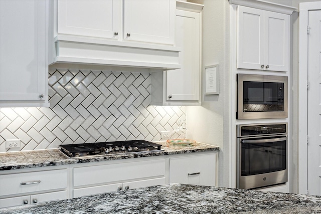 13234 James Terrace Ln, Houston, TX 77059 - kitchen with stainless steel appliances, tasteful backsplash, and white cabinetry