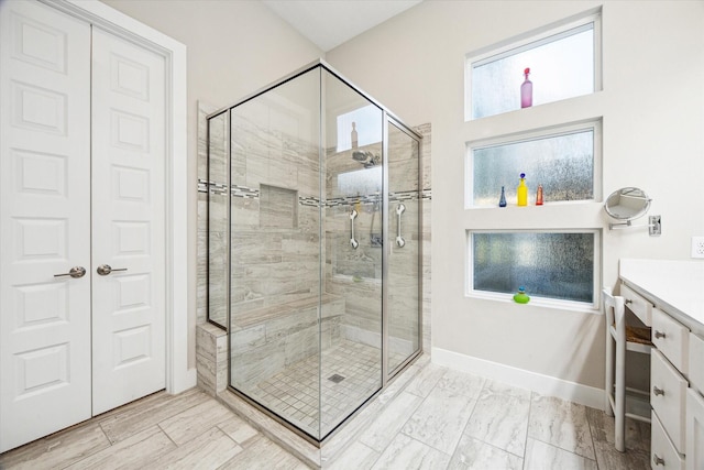 13234 James Terrace Ln, Houston, TX 77059 - bathroom featuring a stall shower, vanity, and baseboards