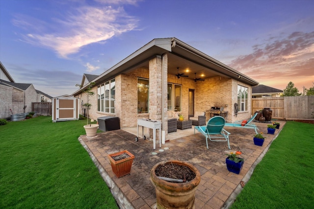 13234 James Terrace Ln, Houston, TX 77059 - rear view of property featuring ceiling fan, a storage unit, brick siding, and a patio