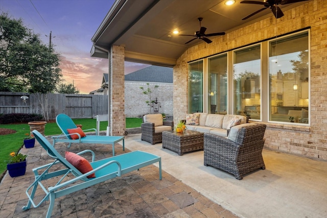 13234 James Terrace Ln, Houston, TX 77059 - patio terrace at dusk featuring ceiling fan, fence, and outdoor lounge area