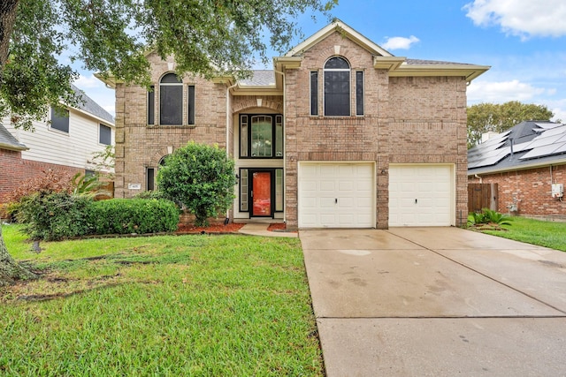 405 Spencer Lndg W, La Porte, TX 77571 - traditional-style house with an attached garage, concrete driveway, a front lawn, and brick siding