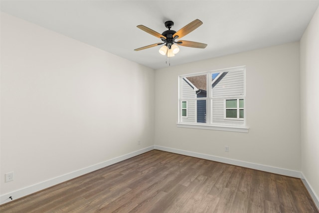 unfurnished room featuring wood finished floors, baseboards, and a ceiling fan