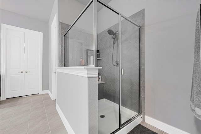 20814 Silver Lance Dr, Tomball, TX 77375 - bathroom with a shower stall, tile patterned floors, and baseboards