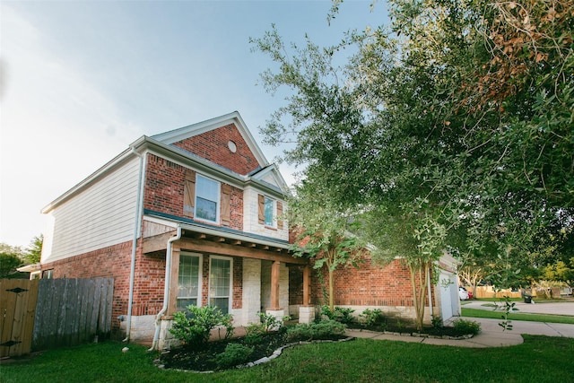 view of front of house featuring brick siding and a porch