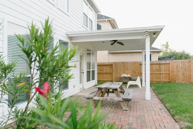 view of patio / terrace with a ceiling fan and fence