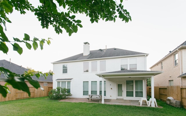 rear view of house featuring a patio and a chimney