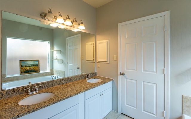 full bathroom featuring a bath, double vanity, and tile patterned floors