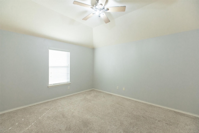 carpeted empty room with ceiling fan, lofted ceiling, and baseboards