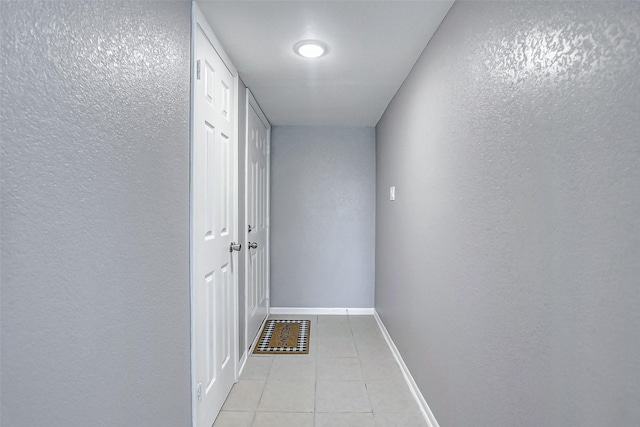 742 Pine Ave, Hempstead, TX 77445 - hall with a textured wall, light tile patterned floors, and baseboards