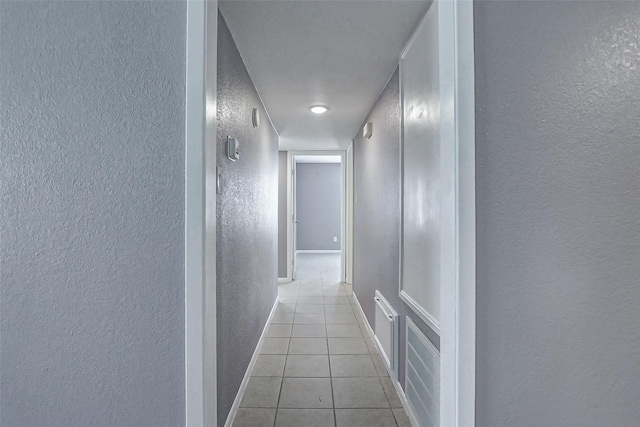 742 Pine Ave, Hempstead, TX 77445 - hall featuring a textured wall, tile patterned flooring, and baseboards