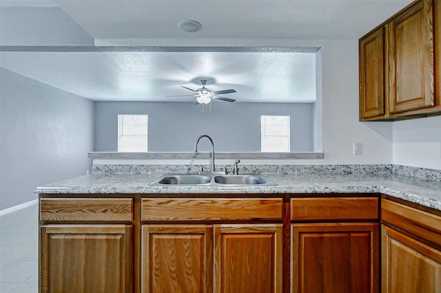 742 Pine Ave, Hempstead, TX 77445 - kitchen with a sink, ceiling fan, and brown cabinetry