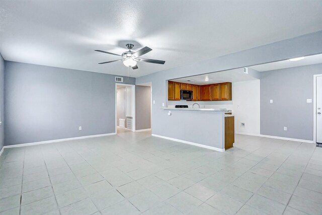 742 Pine Ave, Hempstead, TX 77445 - unfurnished living room featuring a ceiling fan, baseboards, and light tile patterned floors
