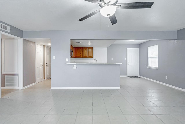 742 Pine Ave, Hempstead, TX 77445 - unfurnished living room with light tile patterned floors, baseboards, a ceiling fan, and a sink