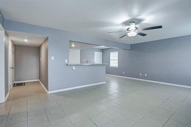 742 Pine Ave, Hempstead, TX 77445 - unfurnished living room featuring a ceiling fan, baseboards, and light tile patterned flooring