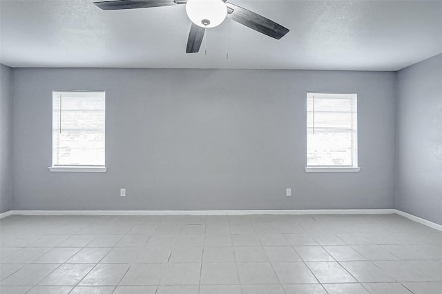 742 Pine Ave, Hempstead, TX 77445 - empty room with light tile patterned floors, baseboards, a ceiling fan, and a textured ceiling