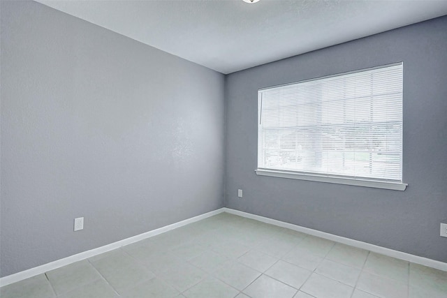 742 Pine Ave, Hempstead, TX 77445 - spare room with baseboards and light tile patterned flooring