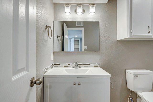 742 Pine Ave, Hempstead, TX 77445 - bathroom with a textured wall, toilet, and vanity