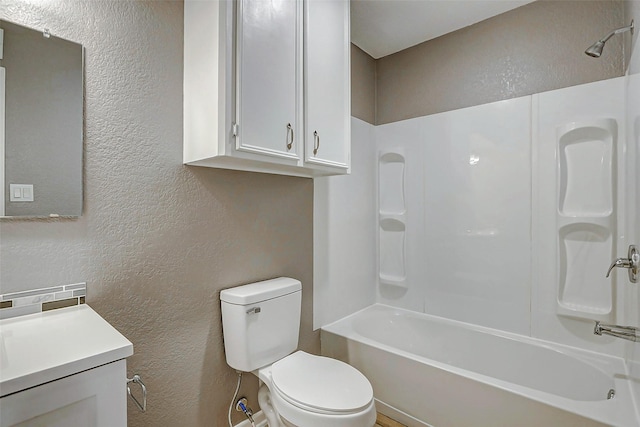 742 Pine Ave, Hempstead, TX 77445 - bathroom with a textured wall, toilet, vanity, and bathtub / shower combination