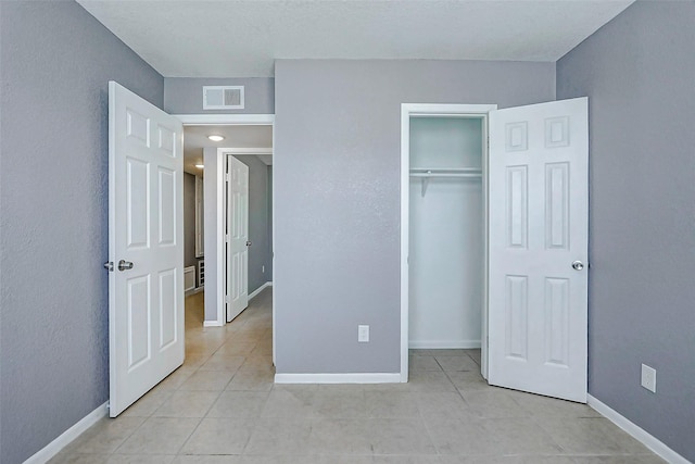 742 Pine Ave, Hempstead, TX 77445 - unfurnished bedroom with light tile patterned floors, a closet, and baseboards