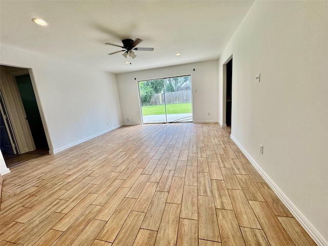 empty room with a ceiling fan, light wood finished floors, baseboards, and recessed lighting