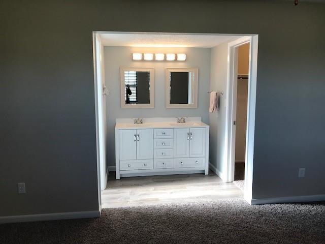 13702 Towne Way Dr, Sugar Land, TX 77498 - bathroom with baseboards and double vanity