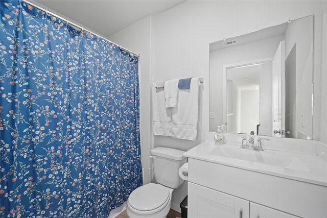 full bathroom with vanity, toilet, and curtained shower