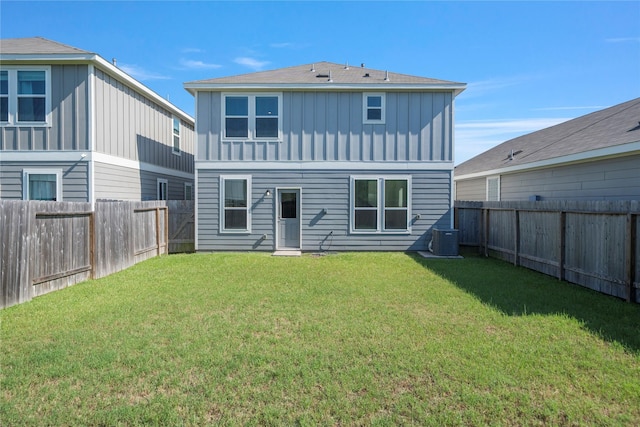 back of house with board and batten siding and central AC