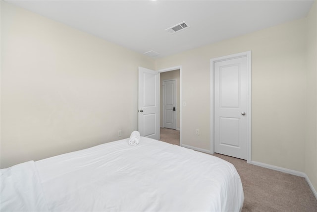 bedroom featuring light carpet and baseboards