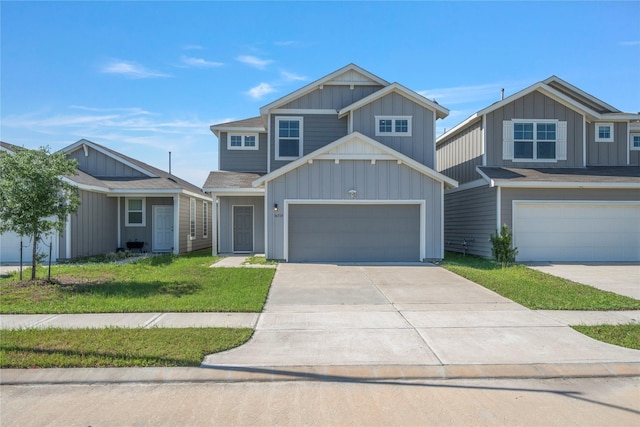view of front of house featuring board and batten siding, driveway, and a front lawn
